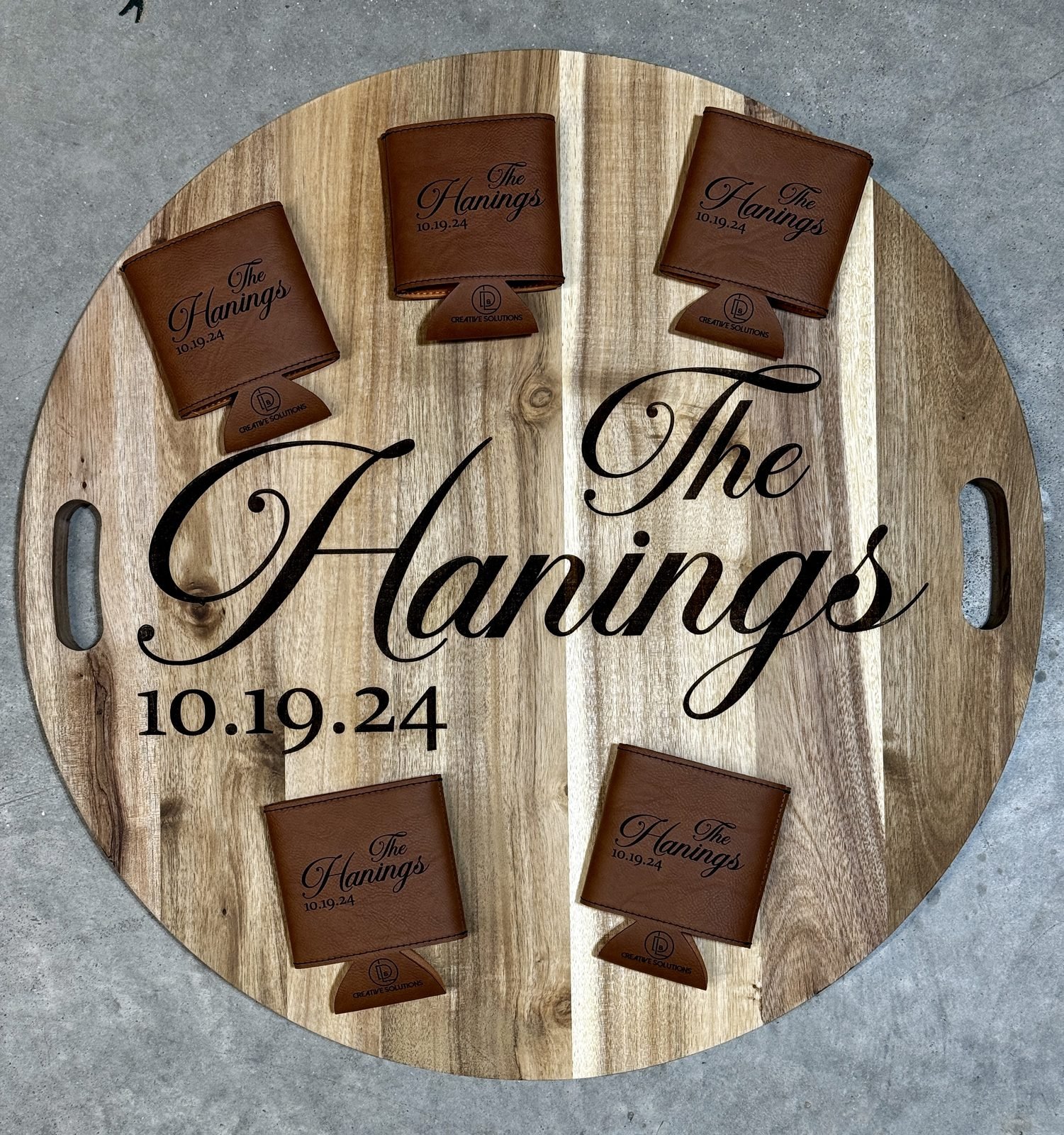 Round personalized wedding serving board with matching leather can coolers