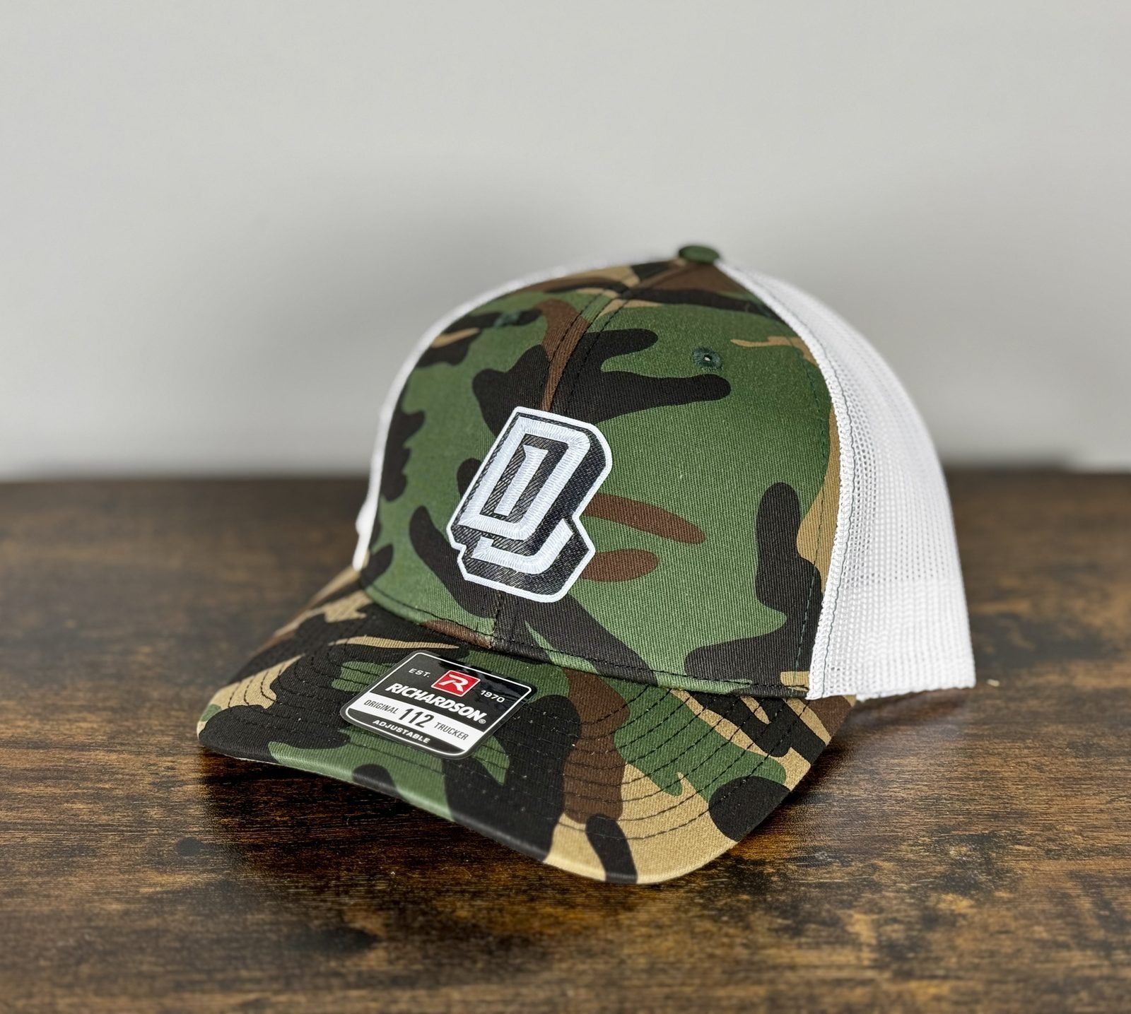 Camouflage and white custom trucker hat with layered monogram patch
