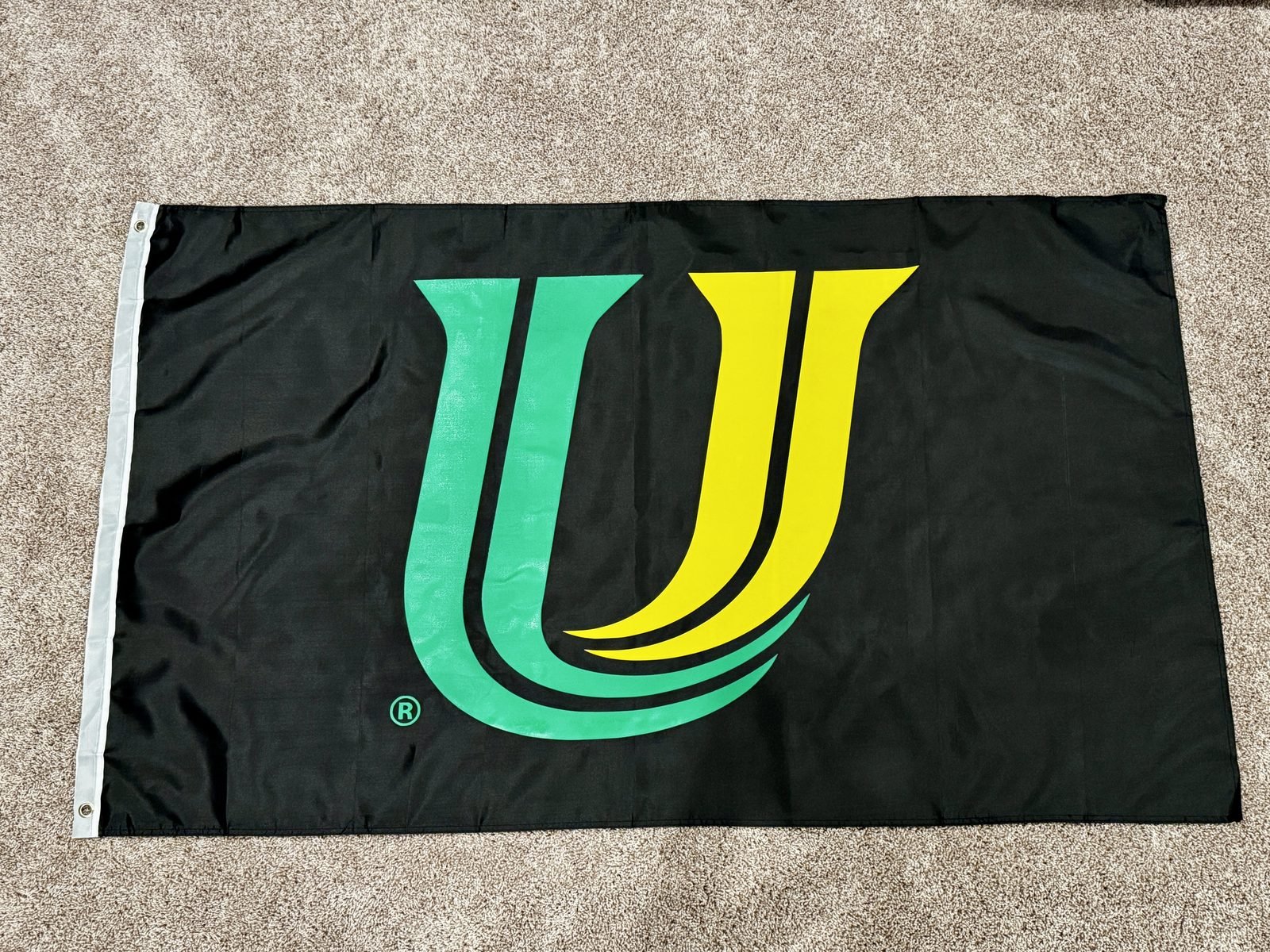 Black custom team flag with green and gold logo