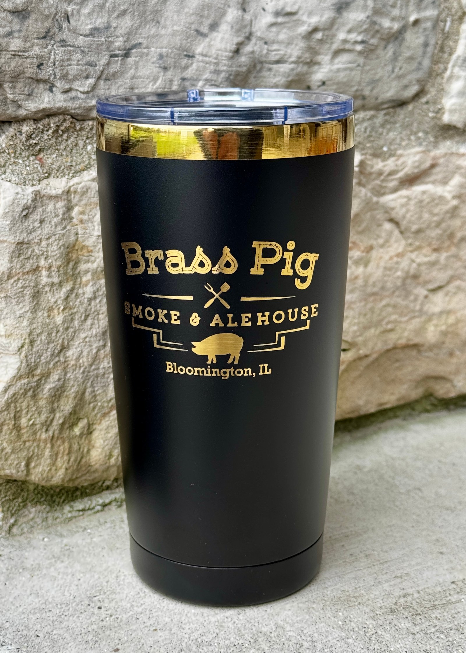 Black tumbler with gold engraved restaurant branding